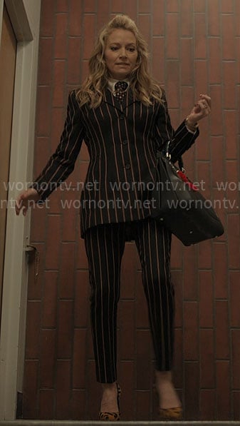 Lorna's striped suit, leopard pumps, and leather bag on The Lincoln Lawyer