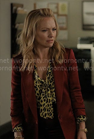 Lorna's yellow leopard blouse and red satin suit on The Lincoln Lawyer