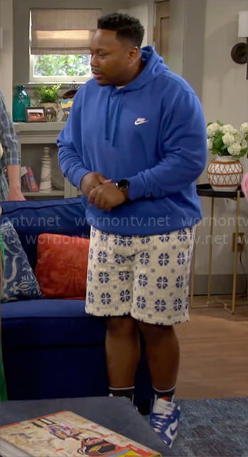 Marty's blue Nike hoodie and printed shorts on The Neighborhood