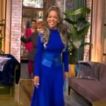 Sunny’s blue mock neck flare dress on The View