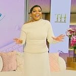 Tamron’s white one shoulder knit top and skirt on Tamron Hall Show