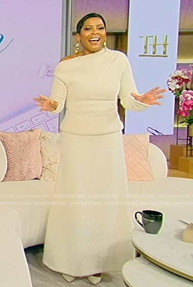 Tamron’s white one shoulder knit top and skirt on Tamron Hall Show