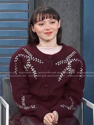 Violet McGraw's burgundy embroidered cardigan and leather skirt on Access Hollywood