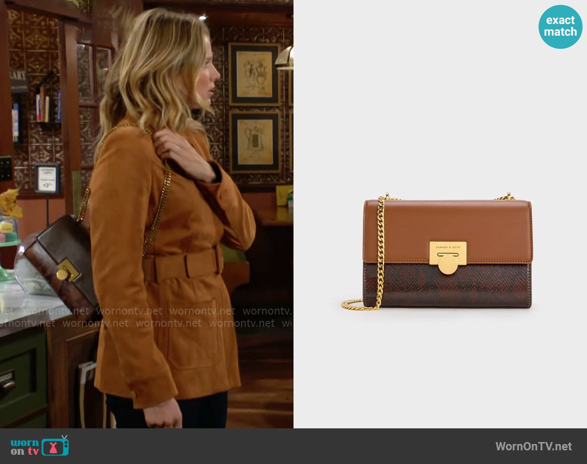 Charles & Keith Snake Print Chain-Strap Bag in Chocolate worn by Summer Newman (Allison Lanier) on The Young and the Restless