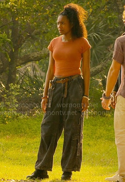 Cleo's orange tee and black cargo jeans on Outer Banks