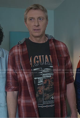 Johnny's black graphic print tee and red plaid shirt on Cobra Kai