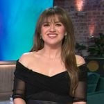 Kelly’s black sheer off shoulder top on The Kelly Clarkson Show