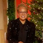 Rachel Boesing’s black tie neck blouse and jacket on Sherri