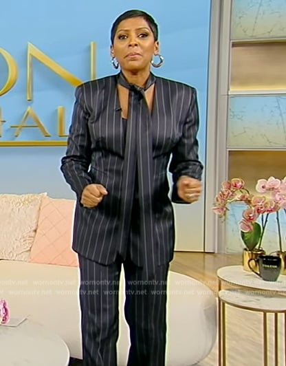 Tamron’s navy pinstripe tie neck blazer and pants on Tamron Hall Show