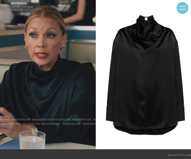 Roselyn Josh’s black satin cowl neck top on Elsbeth