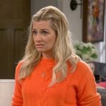 Gemma’s orange cable-knit sweater on The Neighborhood