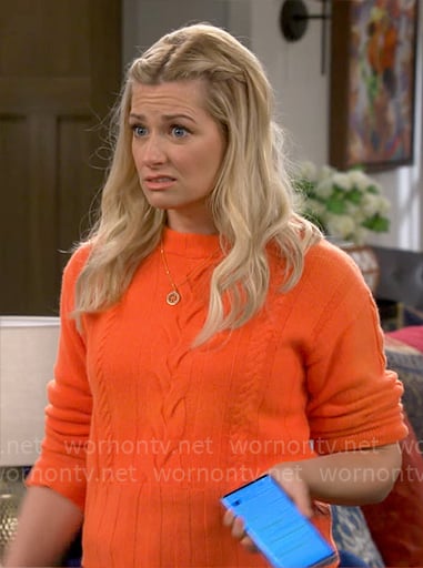 Gemma's orange cable-knit sweater on The Neighborhood