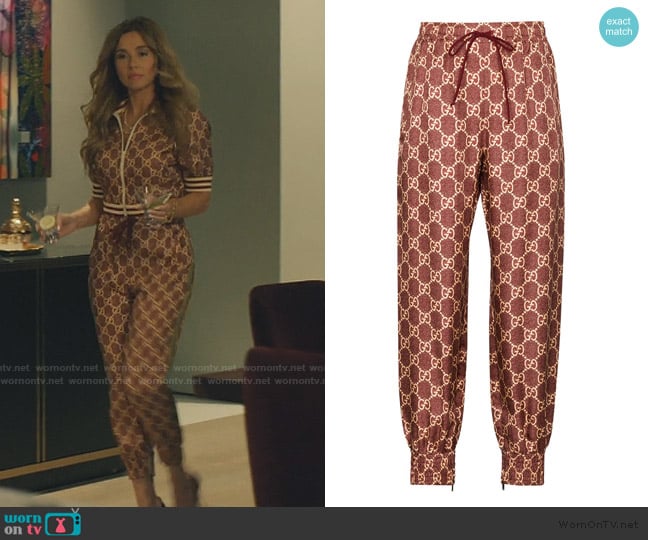 Margo’s burgundy logo track pants on No Good Deed