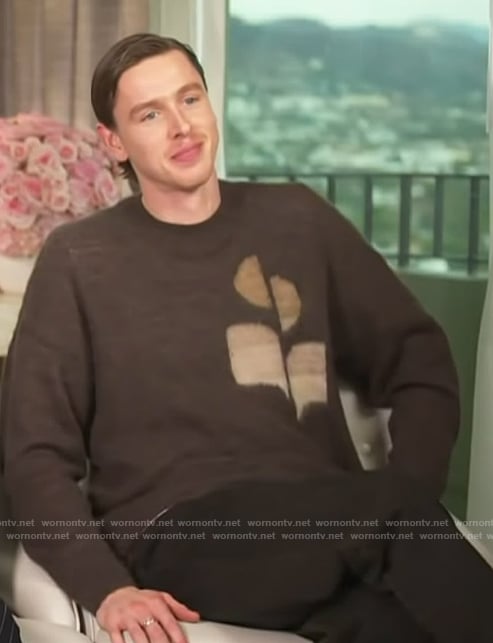 Harris Dickinson's brown logo sweater on Access Hollywood