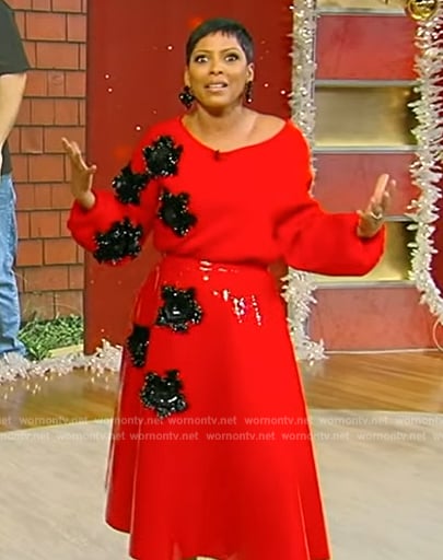 Tamron’s red floral embellished sweater and skirt on Tamron Hall Show