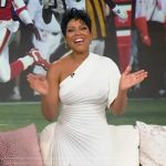 Tamron’s white pleated one shoulder dress on Tamron Hall Show