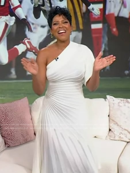 Tamron’s white pleated one shoulder dress on Tamron Hall Show