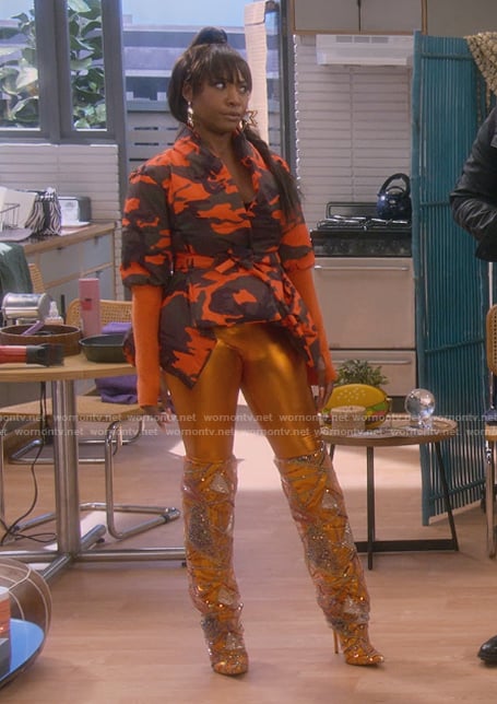 Tasha's orange printed asymmetric top and boots on The Upshaws