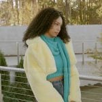 Chelsea’s teal scarf top and heart cutout jeans and yellow fur jacket on Beyond the Gates