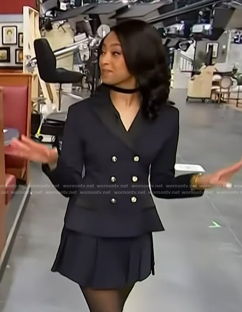 Colby Muhammad’s navy blazer and mini skirt on Access Hollywood