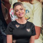 Denise Richards’ black heart cutout mini dress on E! News