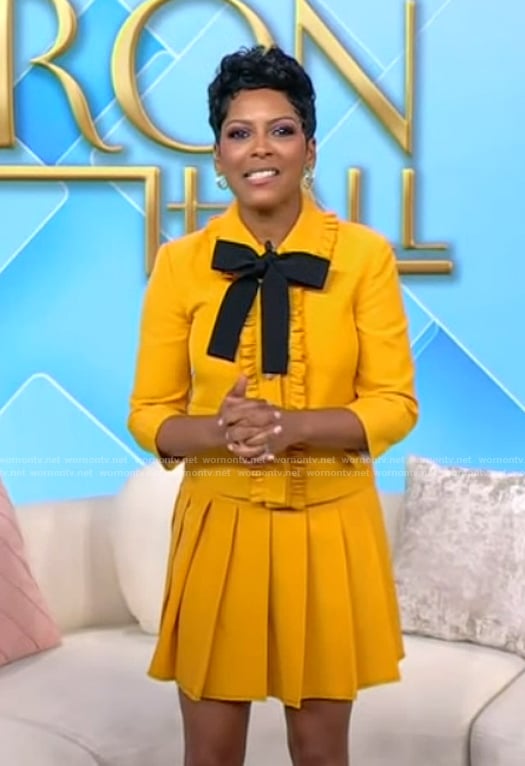 Tamron's yellow tie neck top and skirt on Tamron Hall Show