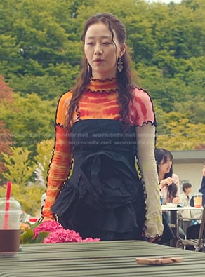 Yuri’s multicolor tie dye top and black rosette dress on XO Kitty