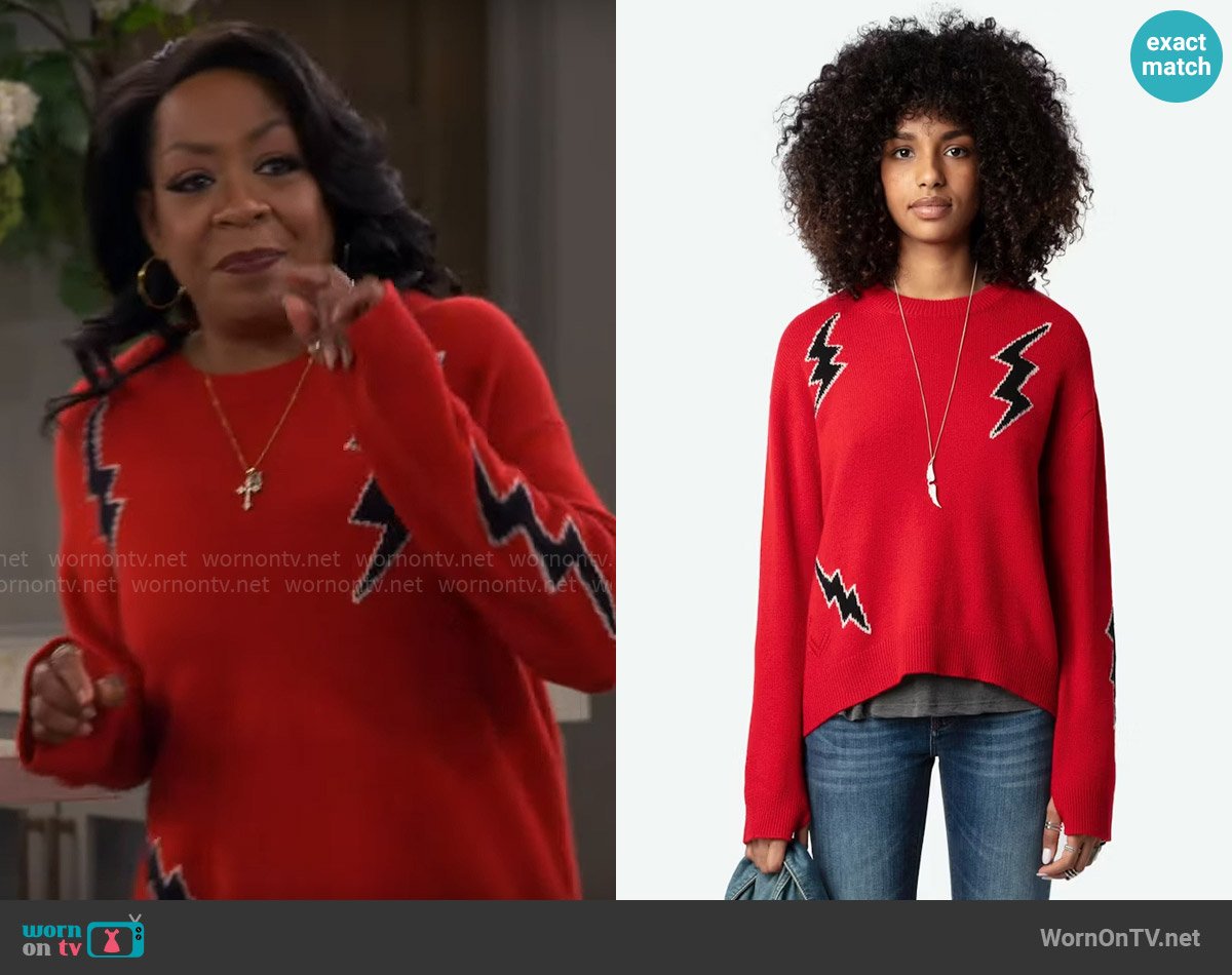 Tina’s red bolt print sweater on The Neighborhood