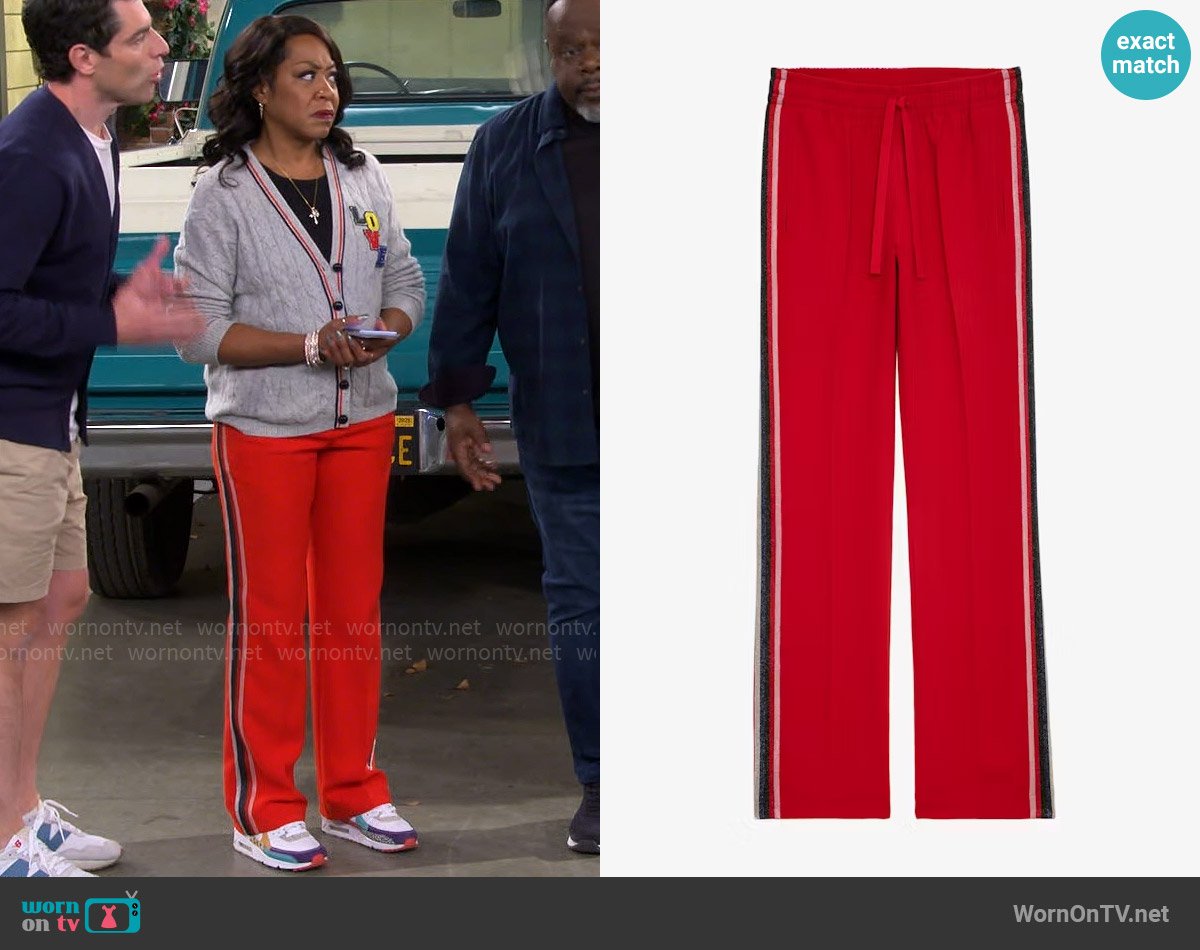 Tina’s red stripe pants on The Neighborhood