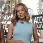 Zuri’s blue sleeveless sweater and brown wrap skirt on Access Hollywood