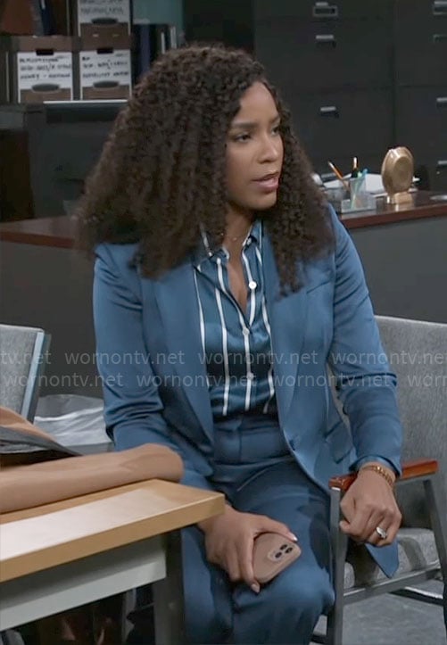 Naomi's teal blue suit and striped button down blouse on Beyond the Gates