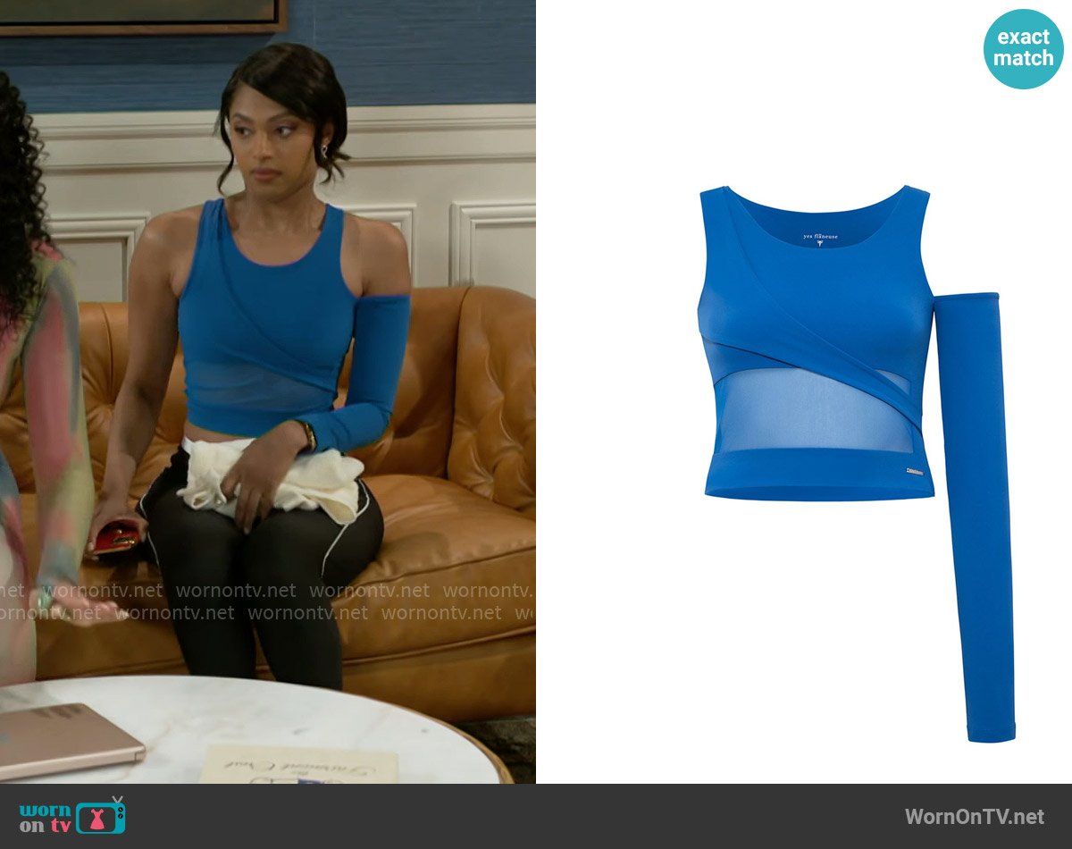 Kat’s blue asymmetric crop top on Beyond the Gates