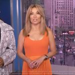 Kit Hoover’s orange pleated dress on Access Hollywood