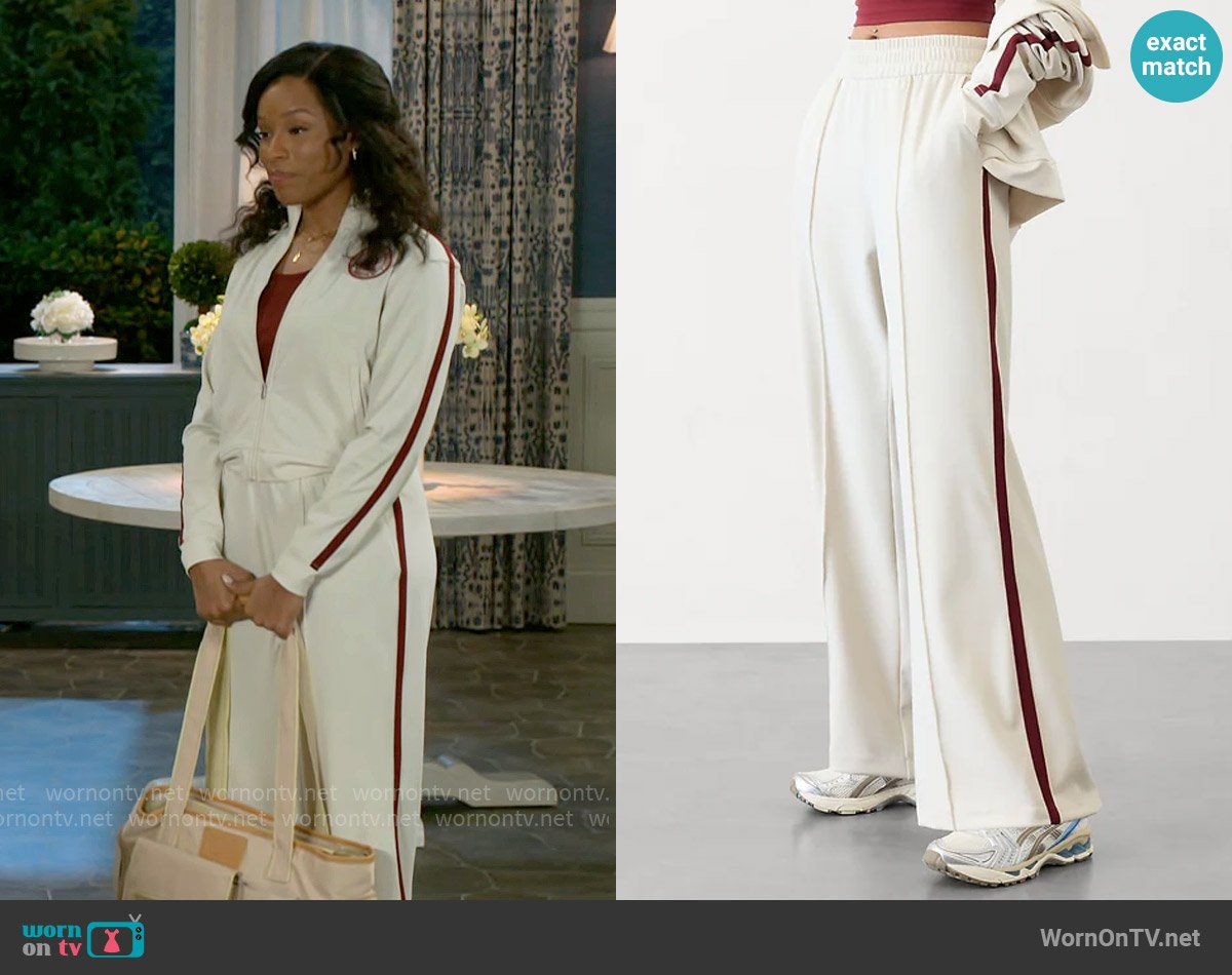 Athleta Finish Line Mid Rise Track Pant in Bone / Redwood worn by Naomi Hamilton Hawthorne (Arielle Prepetit) on Beyond the Gates