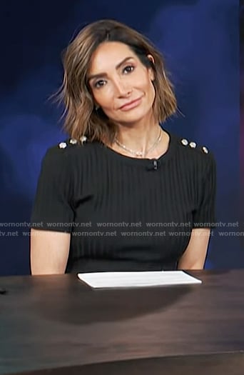 Courtney Lopez’s black button shoulder top on Access Hollywood