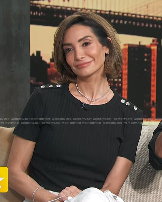 Courtney Lopez’s black button shoulder top on Access Hollywood