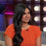 Sam’s orange knit top on The Kelly Clarkson Show