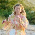 Simone’s orange printed button down shirt on Sirens