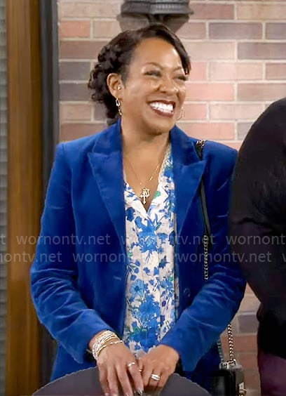 Tina's blue velvet suit and floral blouse on The Neighborhood