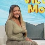 Victoria Monet’s khaki top and skirt on Access Hollywood