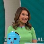 Courtney Cason’s green short-sleeve sweater with blue trims on CBS Mornings
