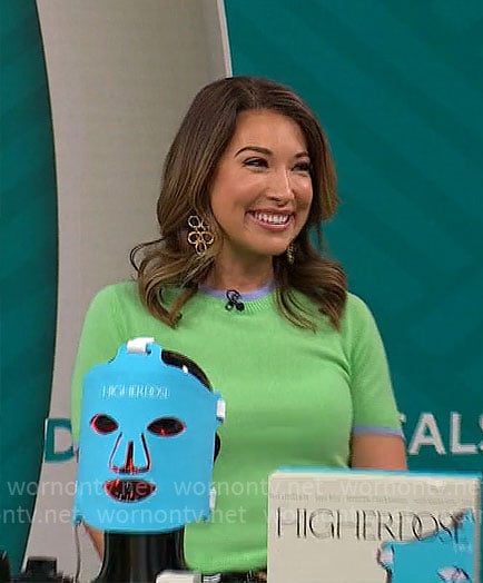 Courtney Cason's green short-sleeve sweater with blue trims on CBS Mornings