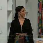 Dani’s blue spike earrings, black top, and printed pants on Beyond the Gates