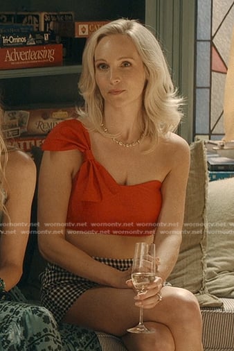 Bess’s red one shoulder bow top and check shorts on We Were Liars