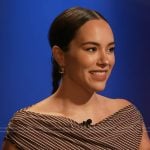 Emily Curl’s brown stripe asymmetric shoulder dress on E! News