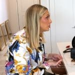 Gina's white printed blouse and leather mini skirt on The Real Housewives of Orange County