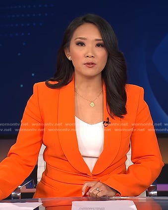 Nancy Chen’s orange blazer and pants on CBS Evening News