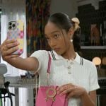 Samantha’s white cable-knit polo top and camel skirt overlay pants on Beyond the Gates