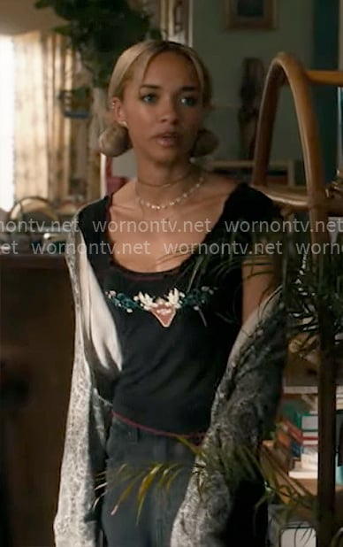 Ava’s black heart graphic top on High Potential