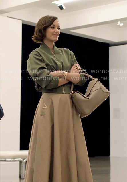 Celine's green bomber jacket and beige skirt on The Morning Show